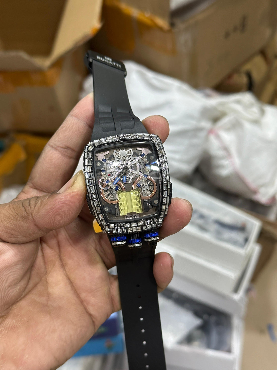 Premium luxury-style men’s watch with transparent skeleton dial, sparkling stone-studded case, and bold blue silicone strap. Perfect for party and fashion wear.